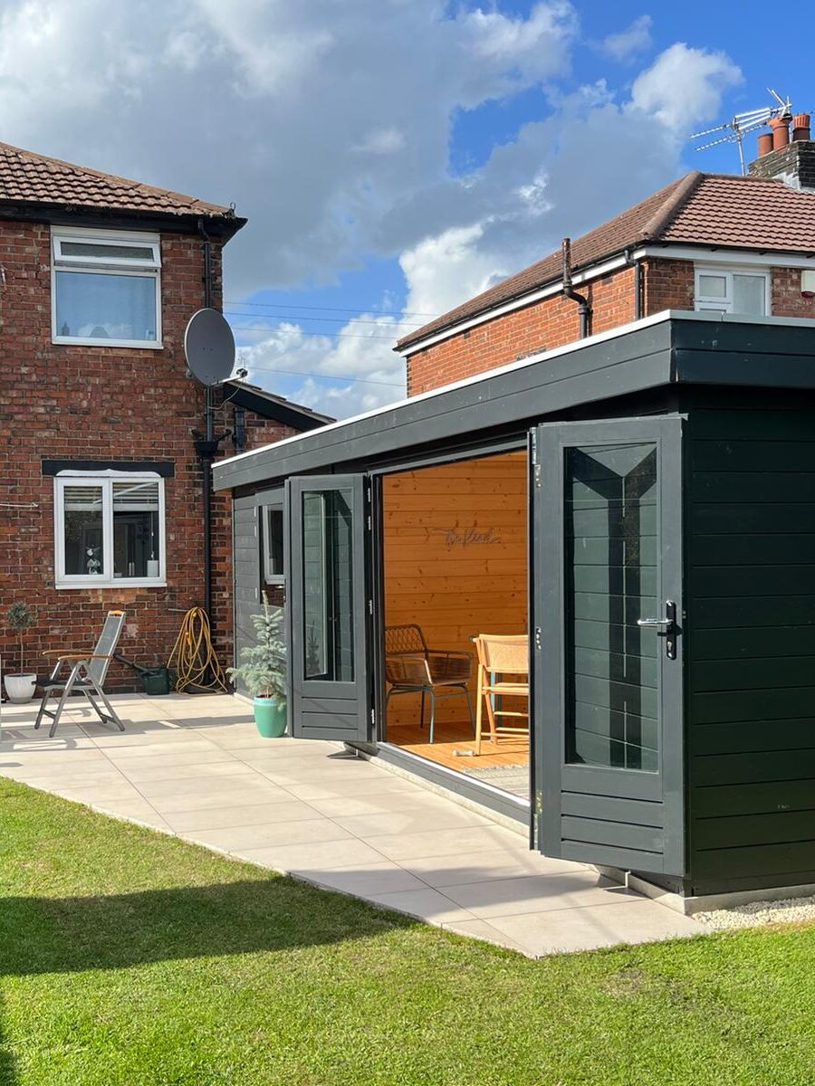Landscaped garden with paving, lawn and garden building completed by Solid Ground in Manchester