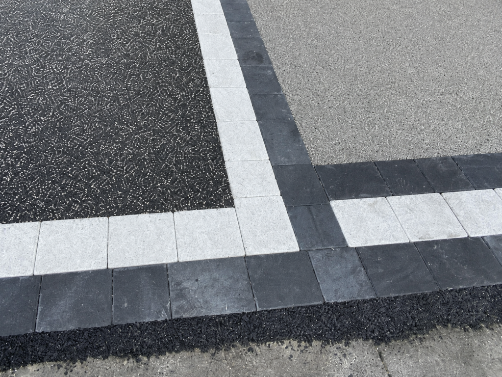 Silver granite and charcoal block border around resin driveway