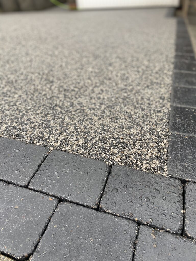 Close-up of bespoke black and silver resin surface and charcoal block border