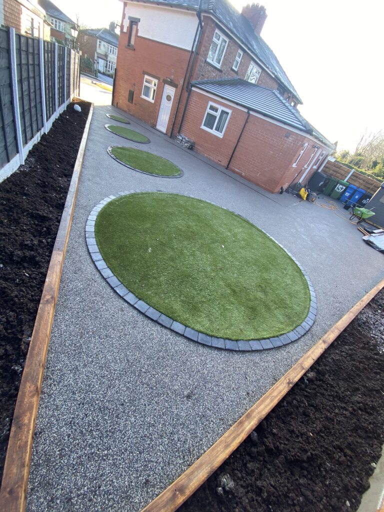 75m² grey resin landscaped garden with artificial grass and sleeper beds