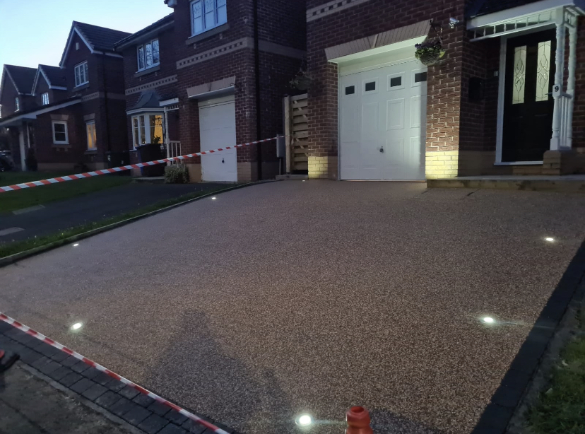 resin driveway installed by soplid ground with lights in stockport