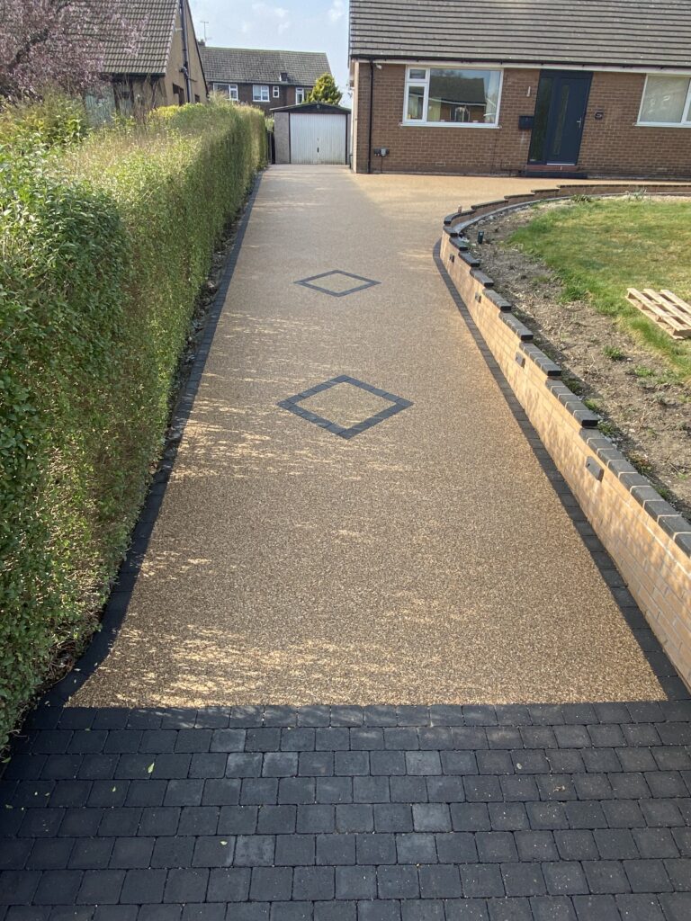 Resin-bound driveway with decorative square block-paved features