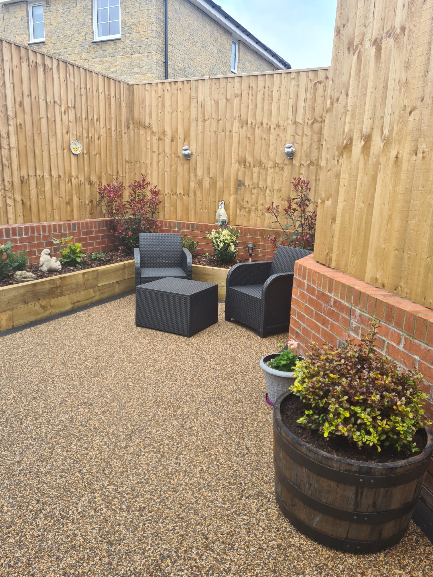 Cappuccino resin patio with sleeper planting beds completed in Hattersley Hyde