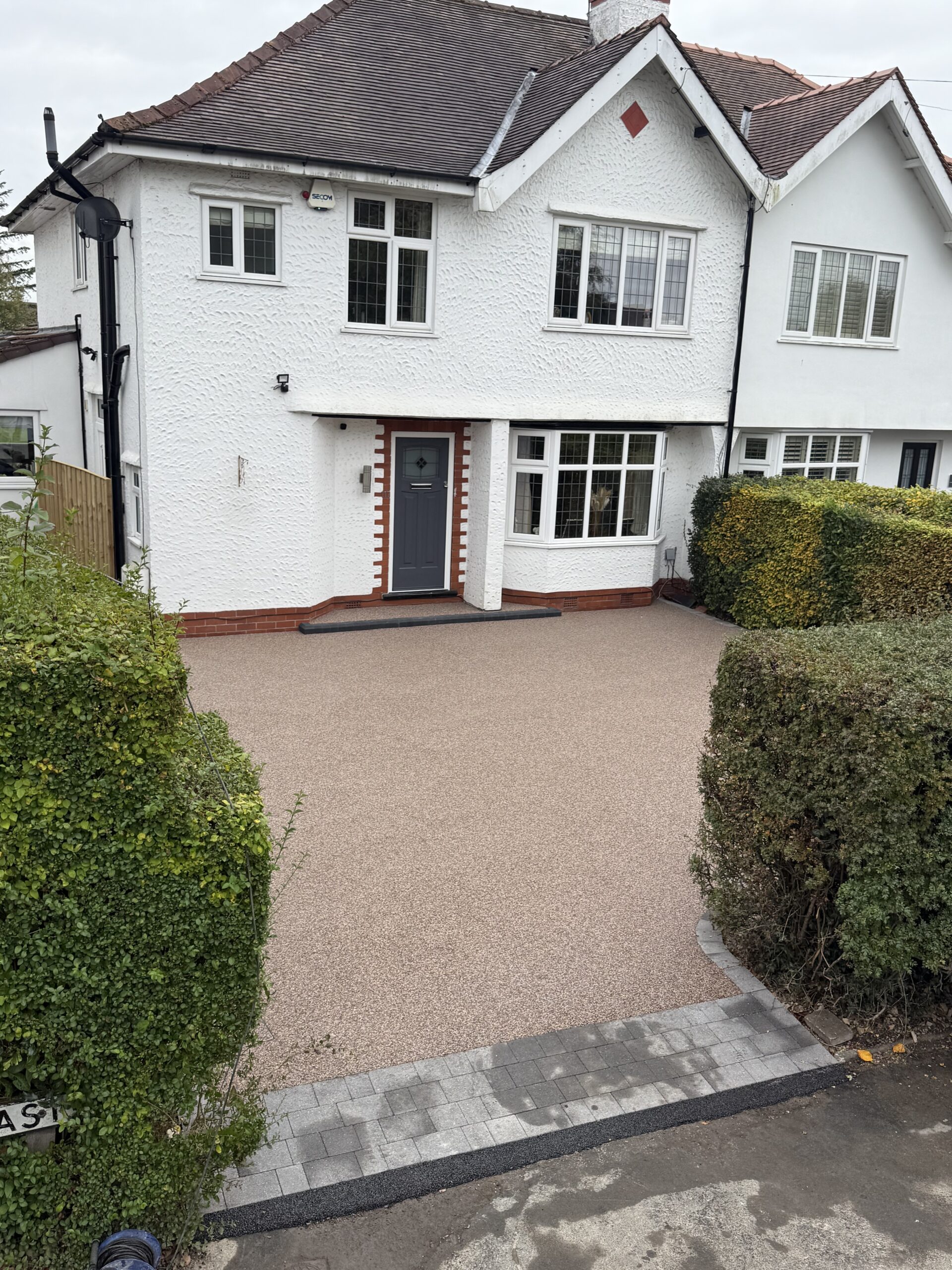 Finished Pink Champagne resin driveway with charcoal edging and new front step in Bramhall, Stockport