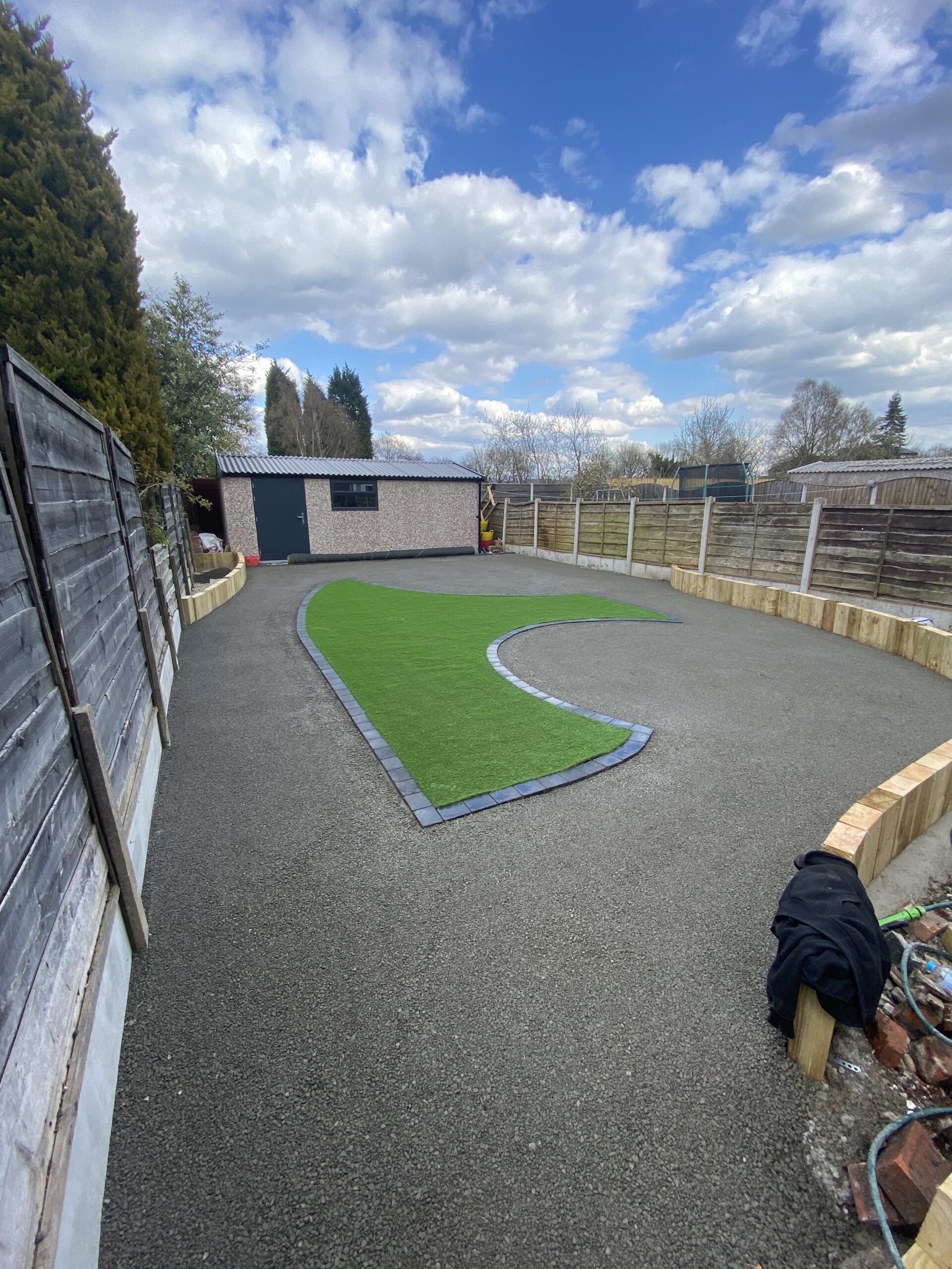 Aurora resin-bound garden transformation with artificial lawn and raised sleeper planters in Heaton Chapel