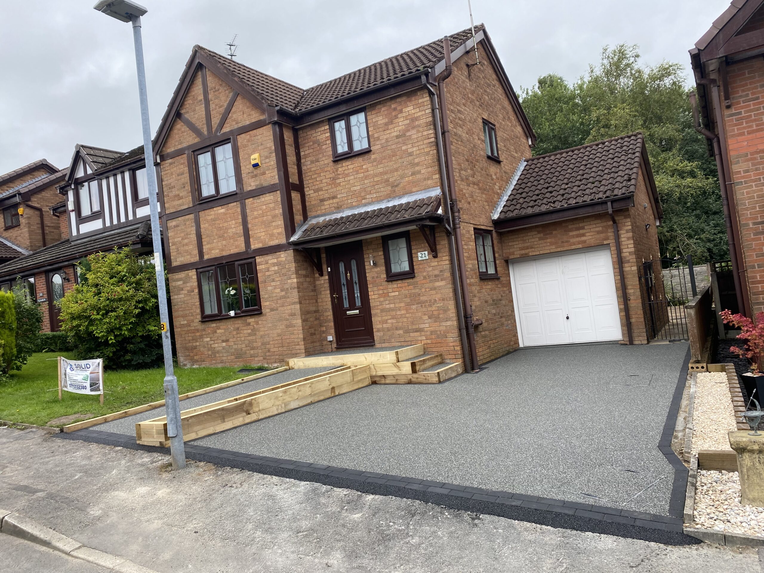 Finished 35m² Slate Grey resin driveway in Hyde with charcoal block border