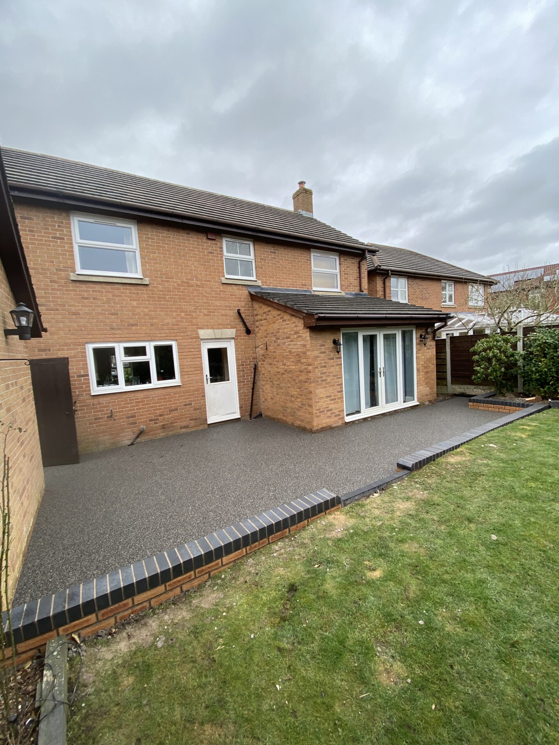 Resin-bound patio installation with new brick walls in Warrington