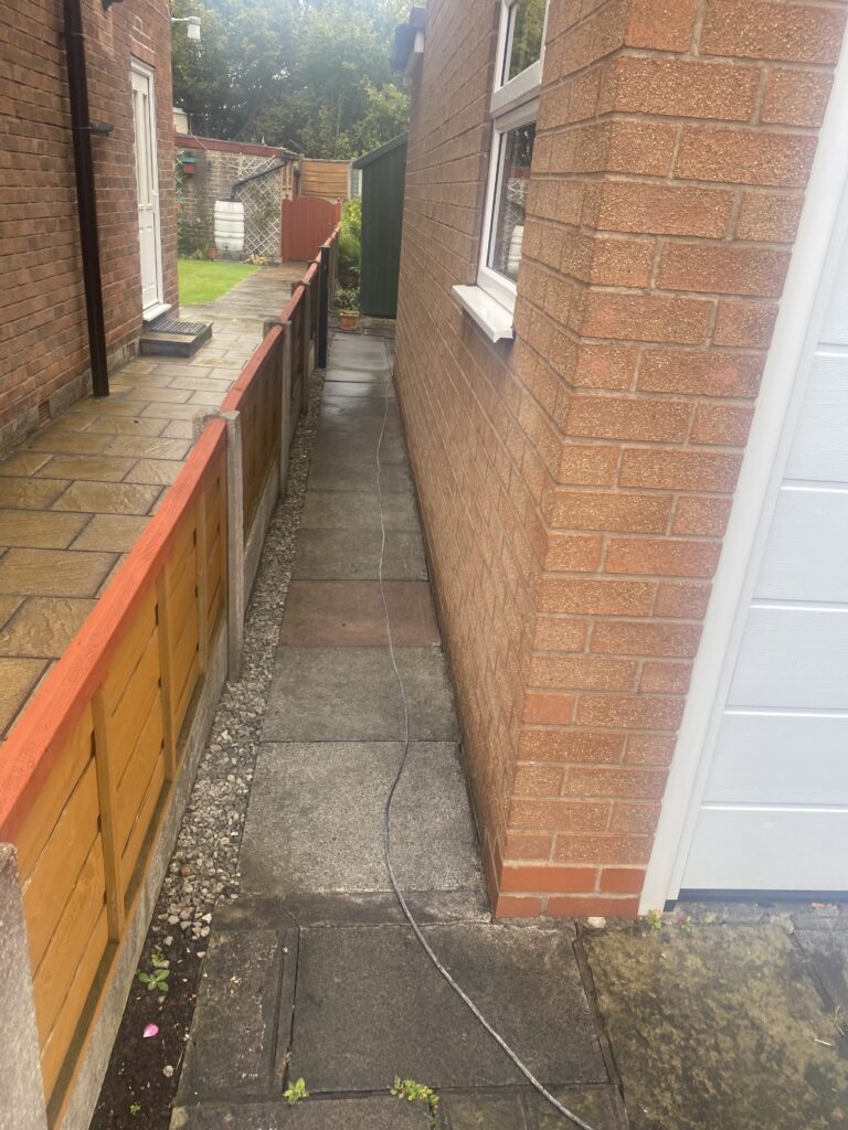 Sienna resin patio and pathway installation in Wilmslow with charcoal block edging