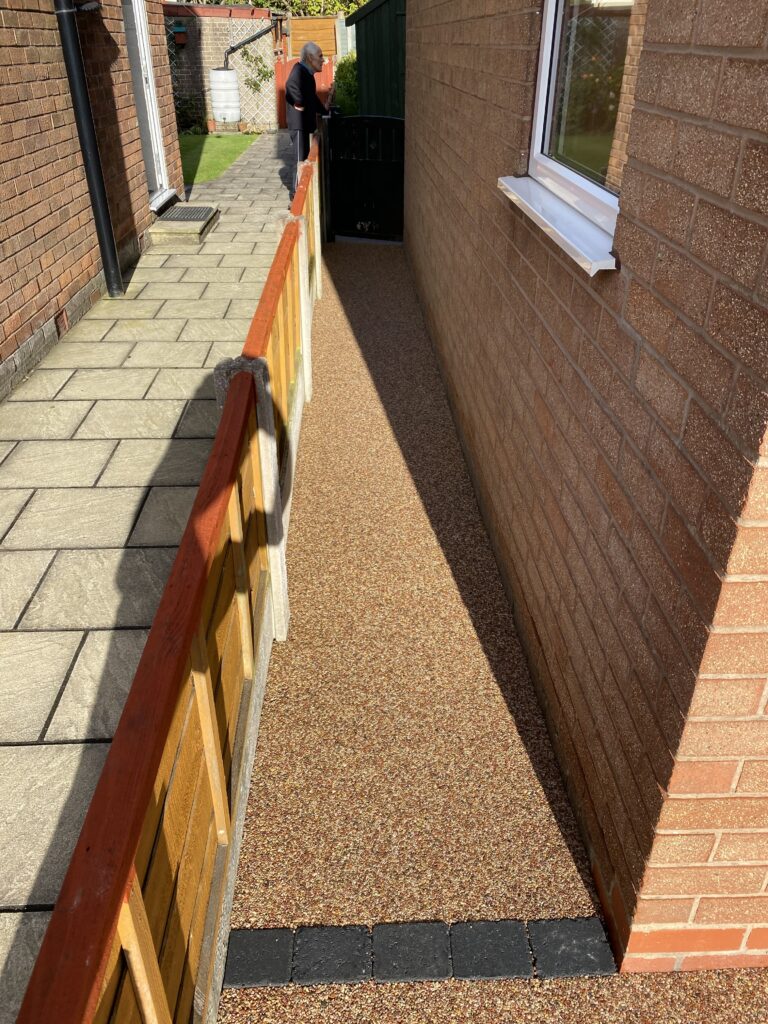 Sienna resin patio and pathway with charcoal block border in Wilmslow