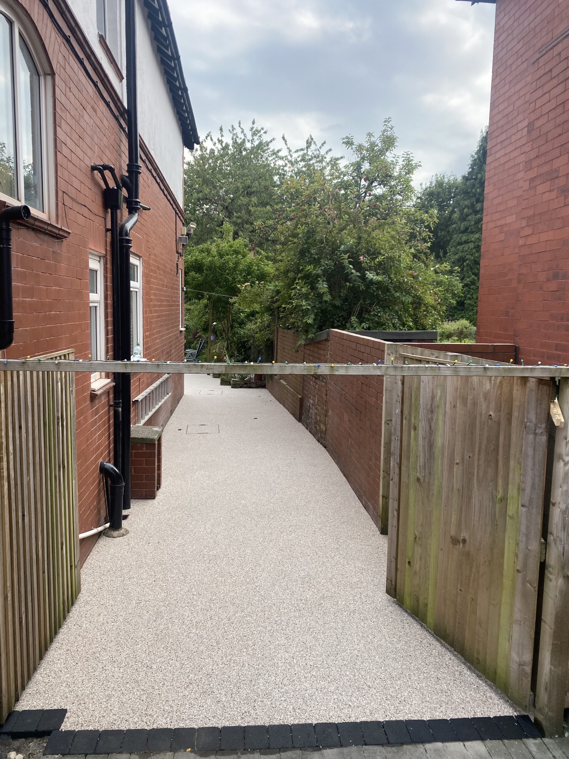 Glacier resin patio in Romiley with charcoal edging blocks
