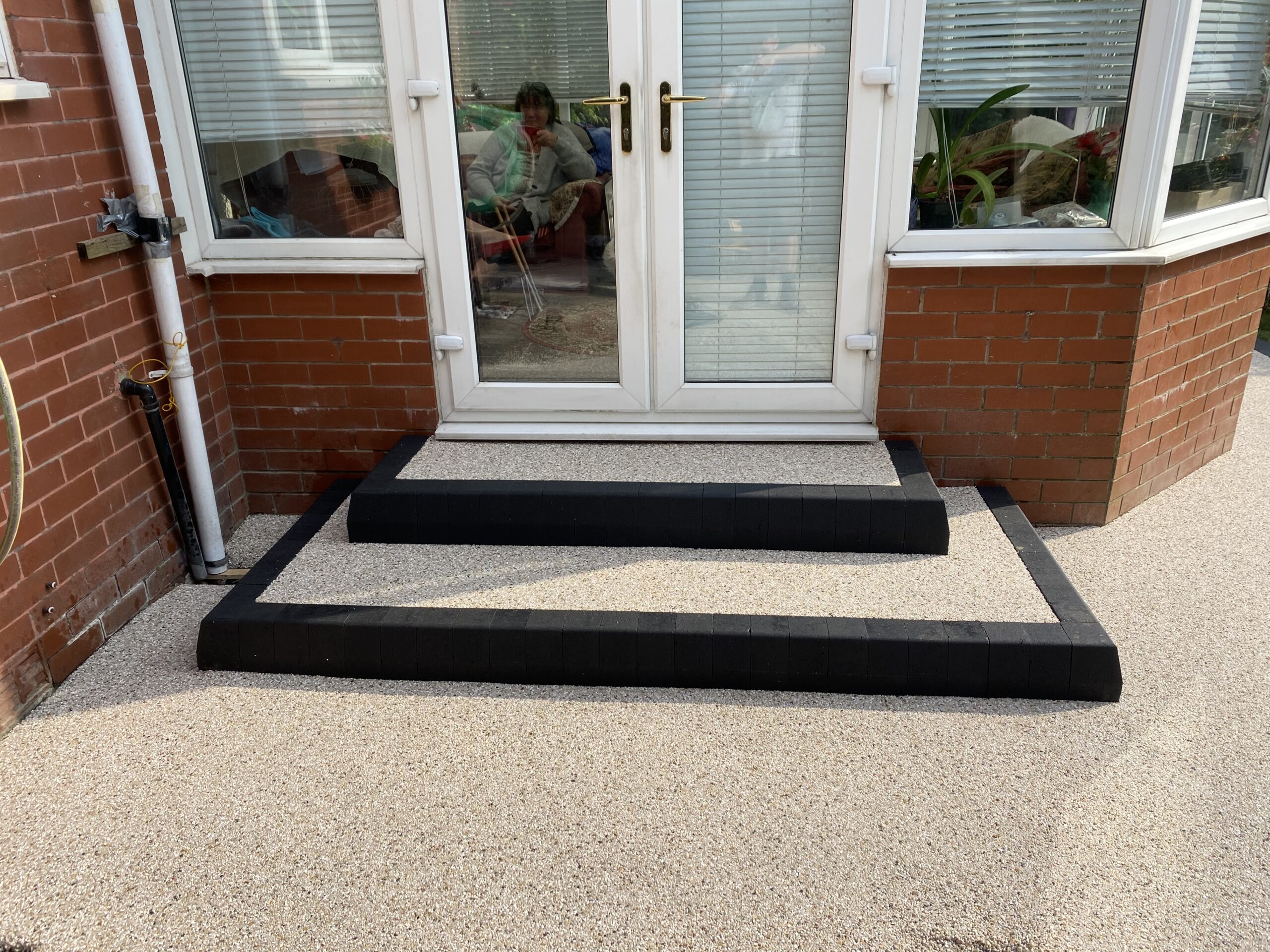 Completed Glacier resin patio areas with charcoal edging in Romiley