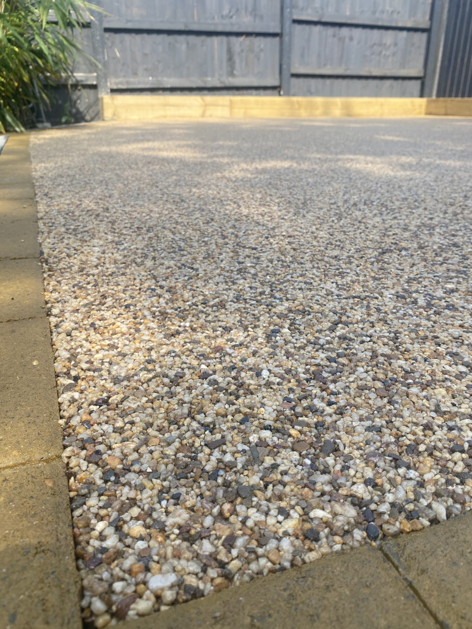 Resin patio detail around an inspection cover in Stalybridge