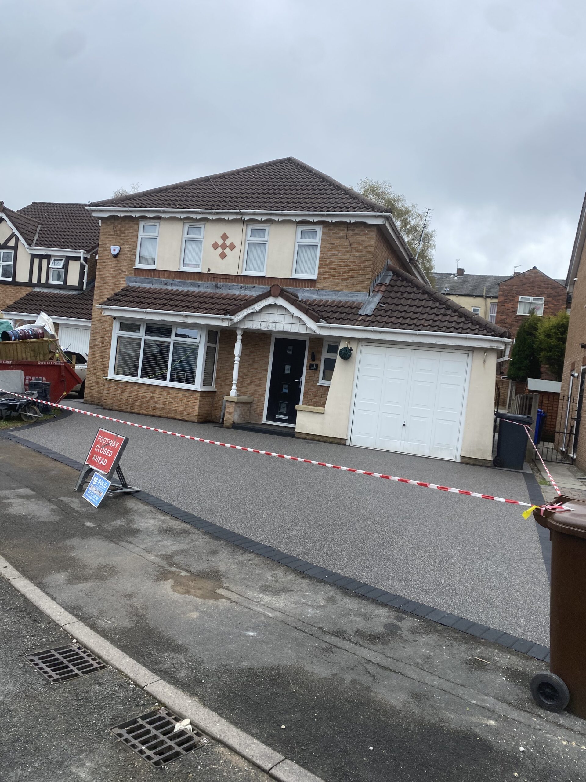 Finished resin patio with timber steps and edging in Stalybridge