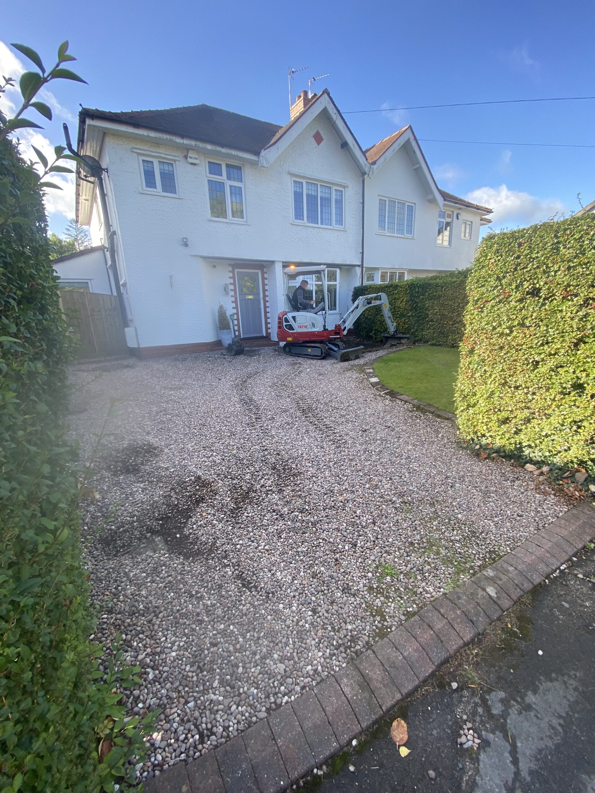 Loose-stone driveway before excavation for Pink Champagne resin installation in Bramhall