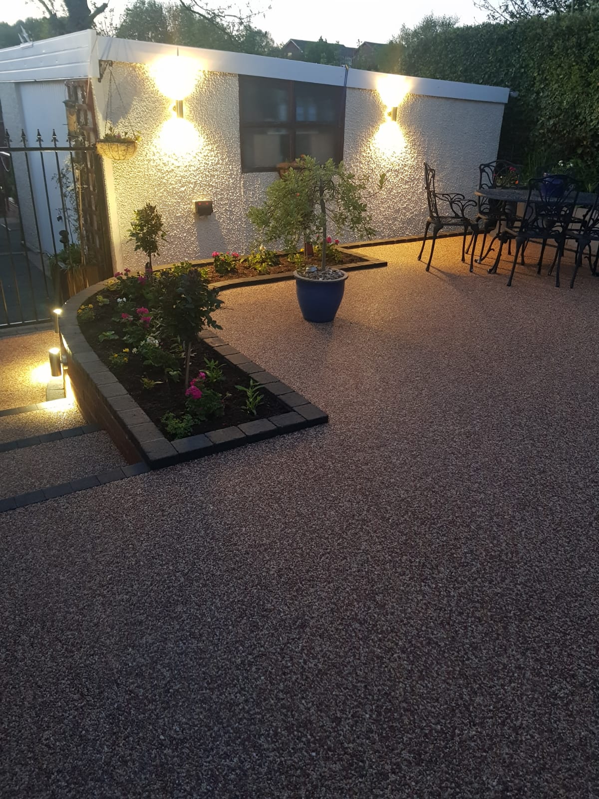 Sienna resin patio in Bredbury with raised flower bed and lighting