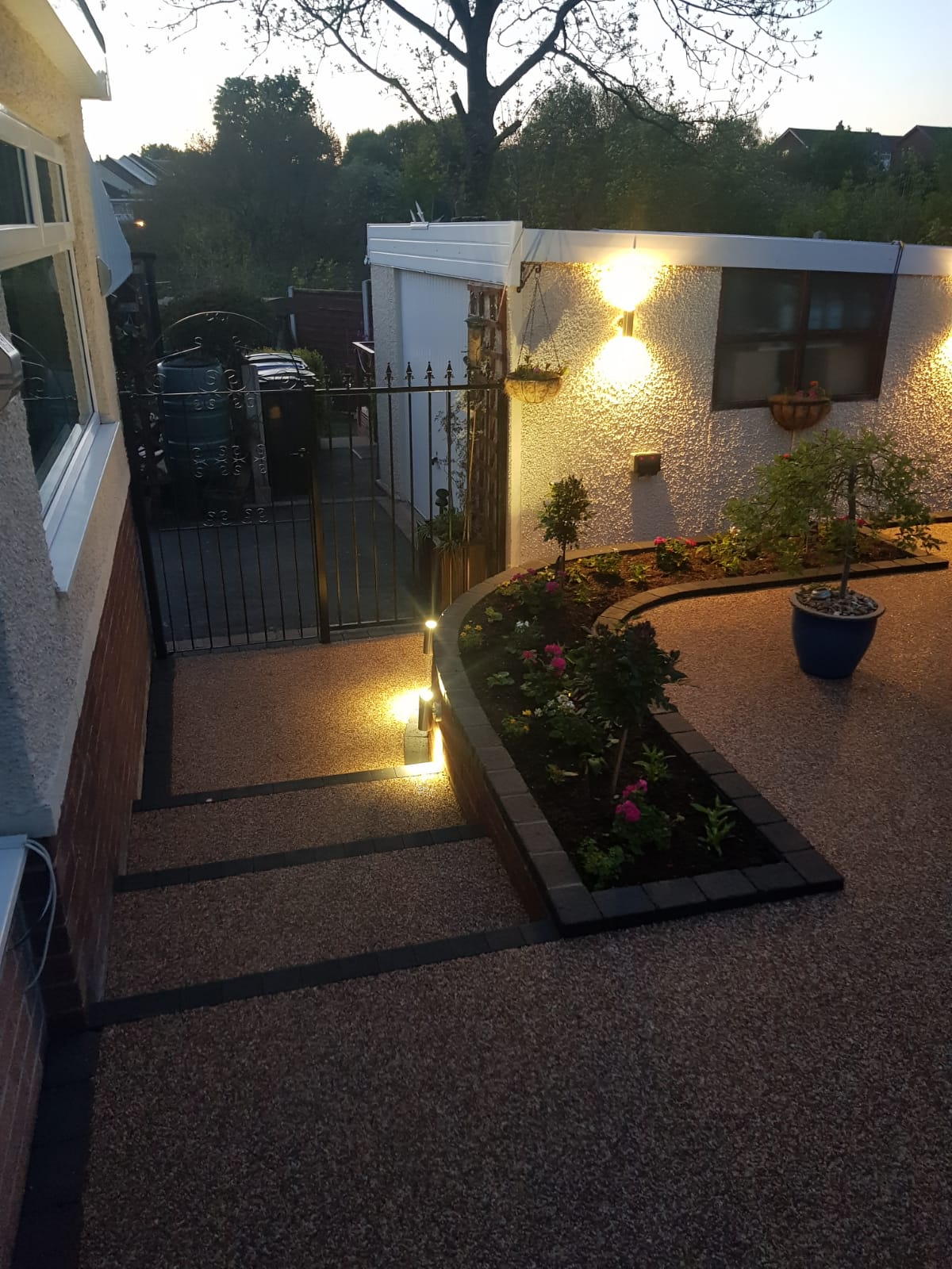 Bredbury Sienna resin patio with charcoal edging and raised flower bedding area