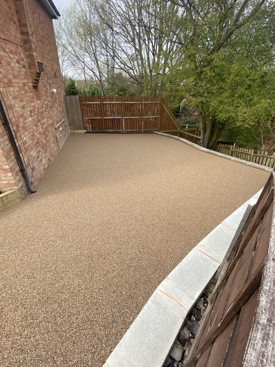 Finished Cappuccino resin-bound driveway in Hyde, viewed towards the rear gate